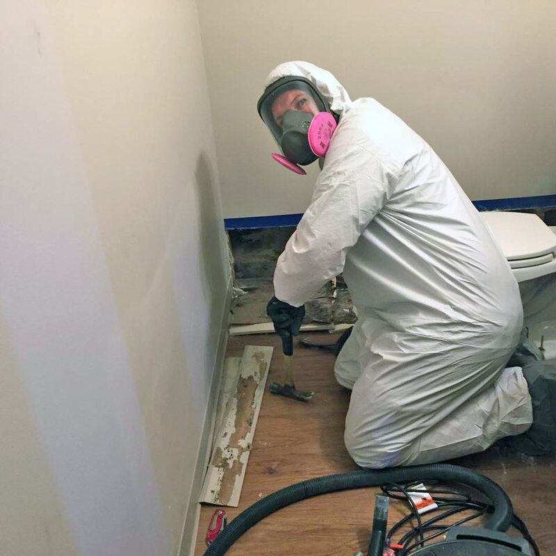 Certified mold removal company technician in full protective gear performing professional mold remediation in Washington